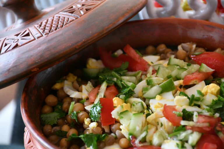 High-angle view of a colorful vegetable salad in a traditional pot, showcasing fresh ingredients.